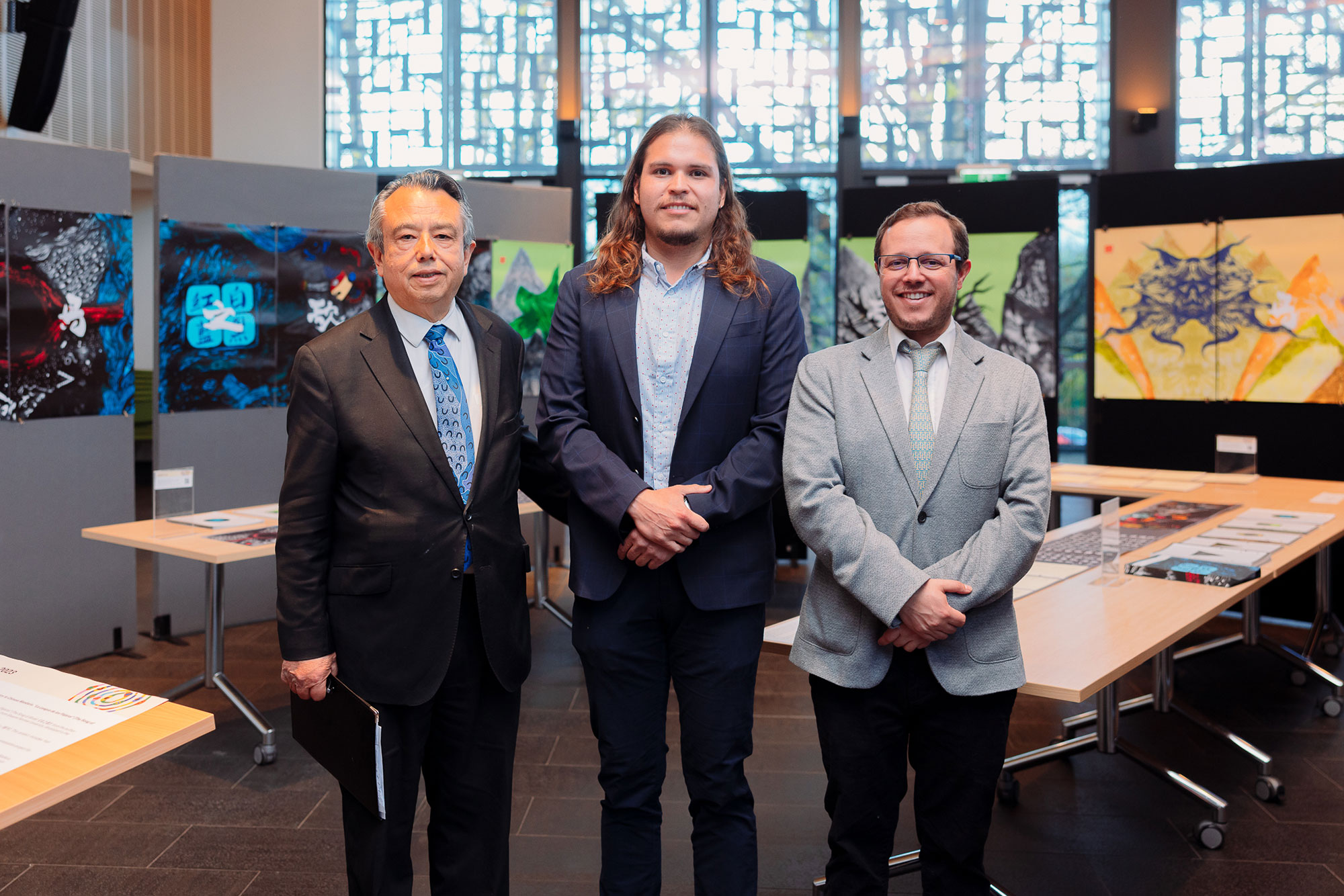 Visitors at the IMMERSIA 2023 exhibition surrounded by artworks and books